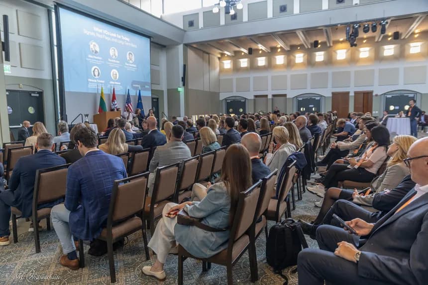 Attendees seated in a full conference auditorium