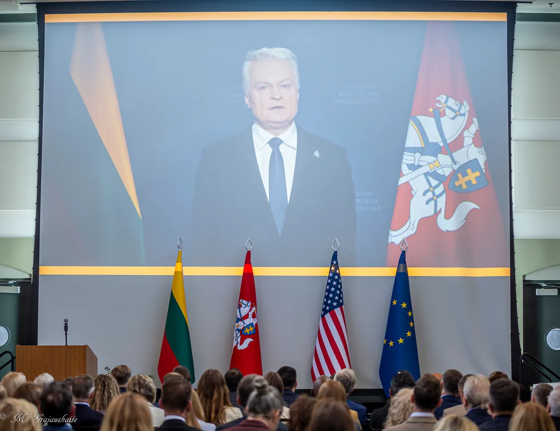 A keynote address projected on a large screen above the audience