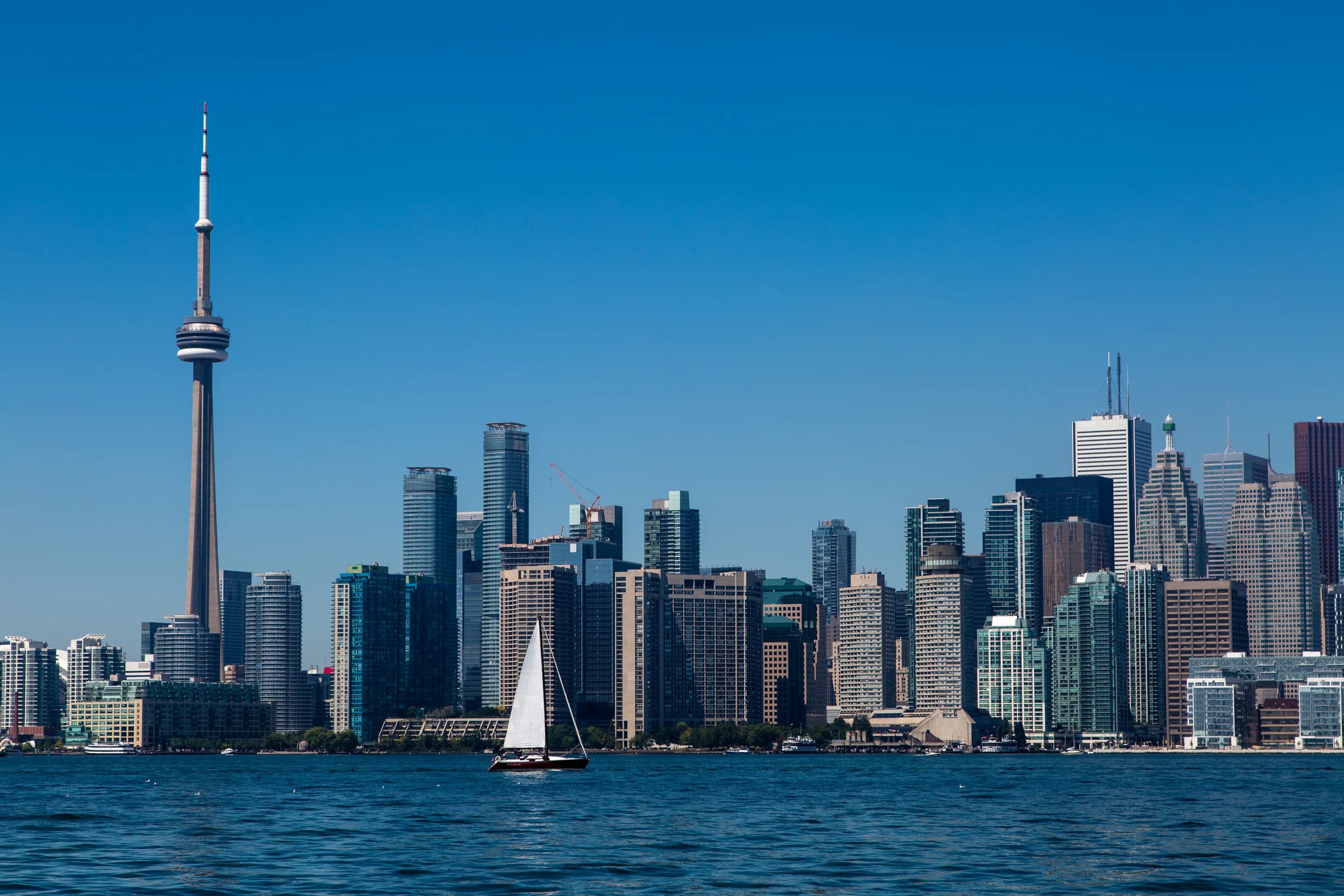 Toronto skyline across Lake Ontario at dusk
